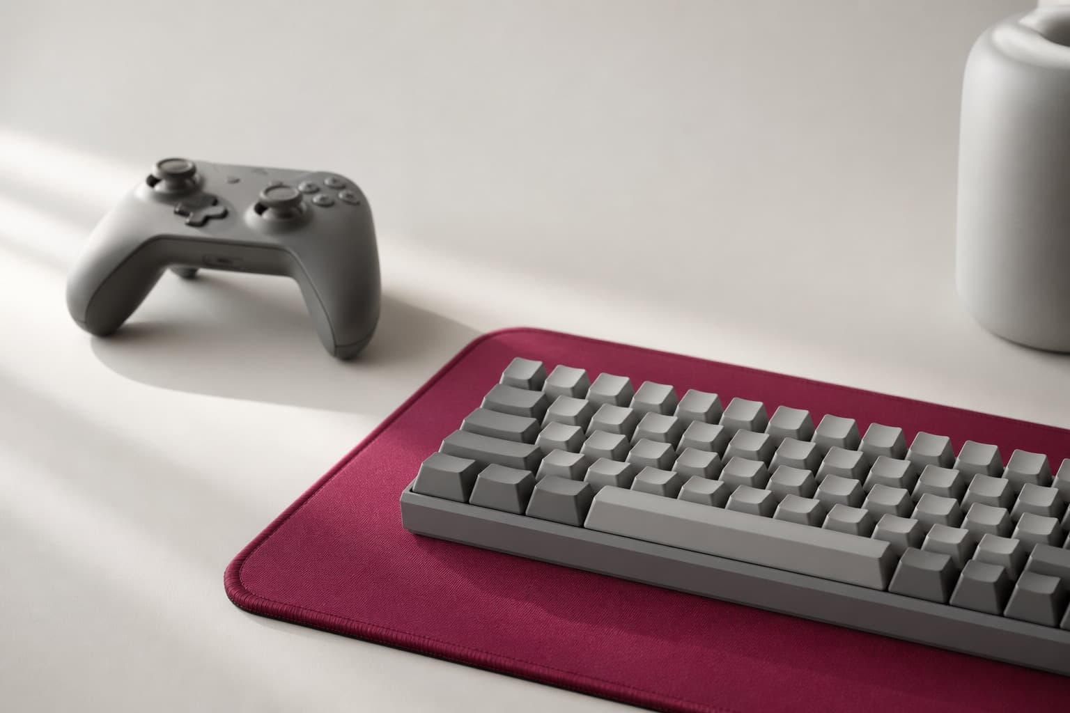 Stillleben: Controller und Tastatur auf beerenrotem Mauspad